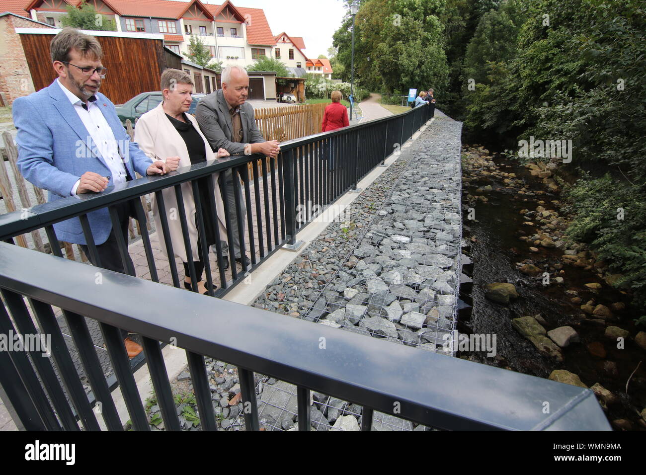 05 September 2019, Saxony-Anhalt, Ilsenburg: Representatives of the Ministry of the Environment of Saxony-Anhalt, the city of Ilsenburg as well as involved construction companies met to visit the bank wall at the Ilse after restoration in the course of the removal of flood damages. In the year 2017 the bank wall at the Ilse collapsed in the course of the flood. Photo: Matthias Bein/dpa-Zentralbild/ZB Stock Photo