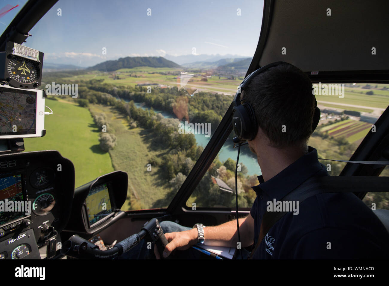 Helicopter pilot flying over river in Bern, Switzerland Stock Photo - Alamy