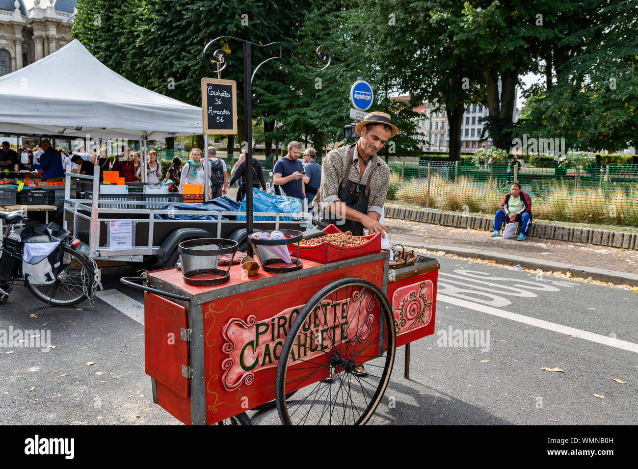 Lille,FRANCE-September 01,2019: Marketplace salesman of roasted nuts on the annual Lille Braderie. Stock Photo