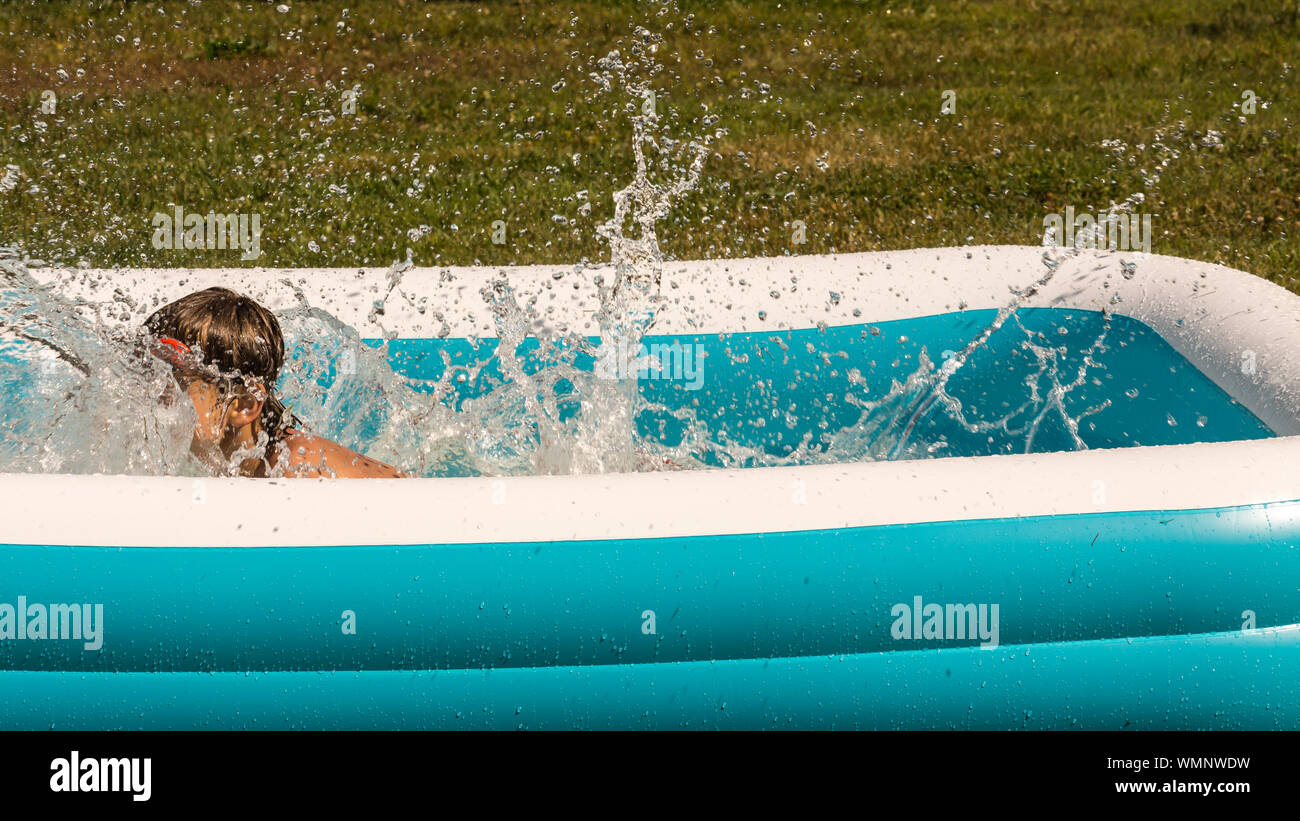 Boy Playing In Wading Pool At Backyard Stock Photo 270929621 Alamy