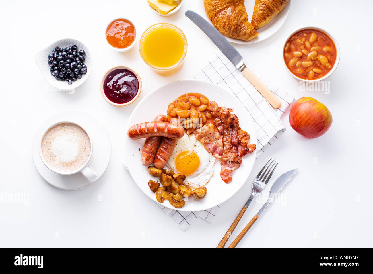 Classical english breakfast with fried bacon, mushrooms and eggs