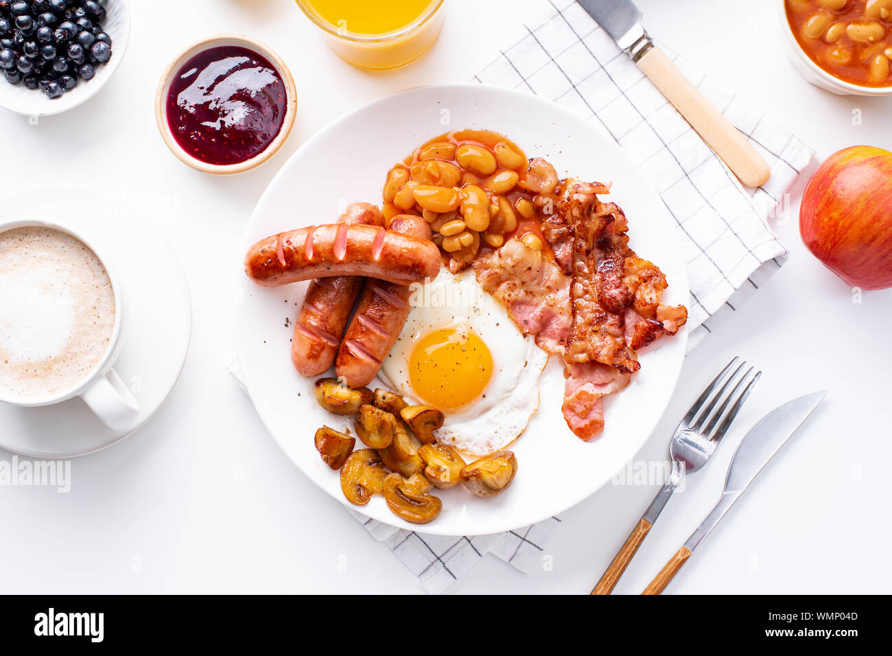 Classical english breakfast with fried bacon, mushrooms and eggs