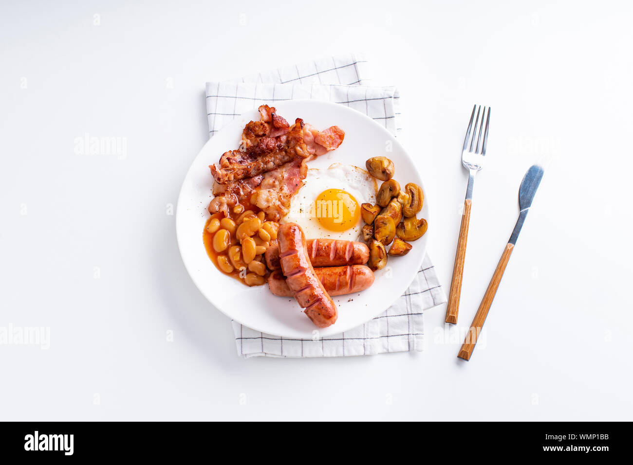 Classical english breakfast with fried bacon, mushrooms and eggs