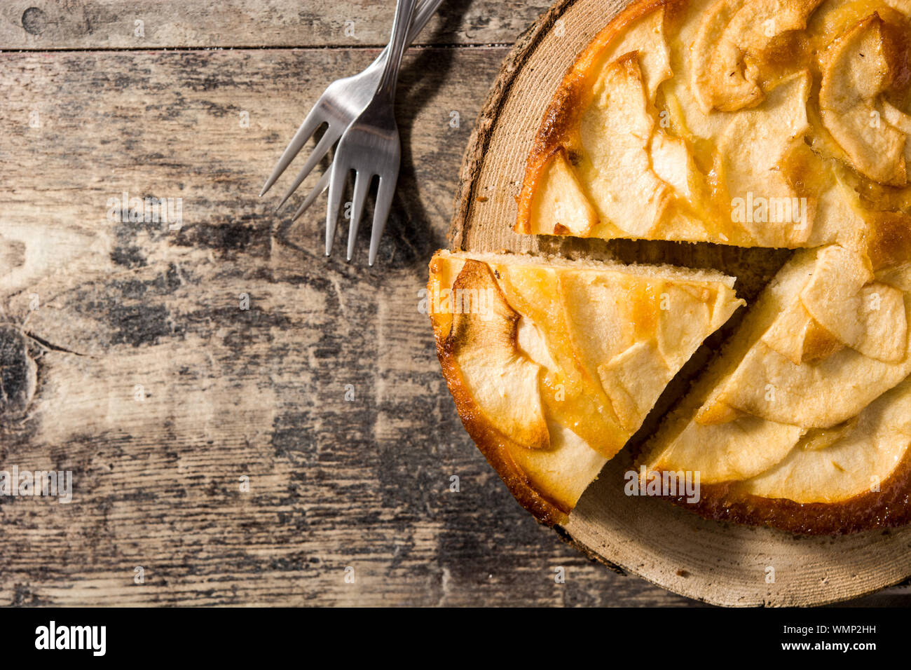 Homemade slice apple pie on wooden table. Copy space Stock Photo