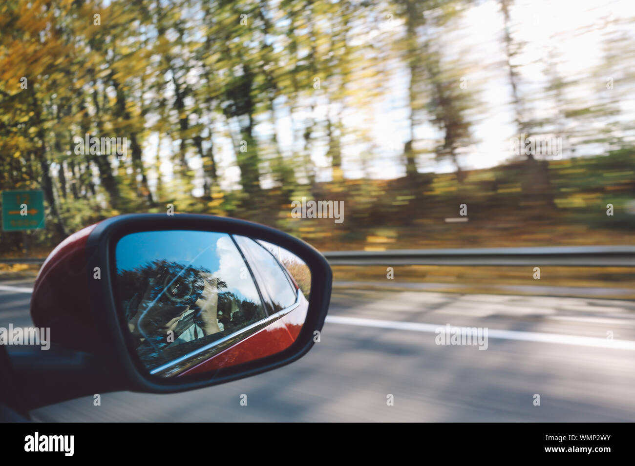 Person Photographing Self Reflection In Side-view Mirror Stock Photo
