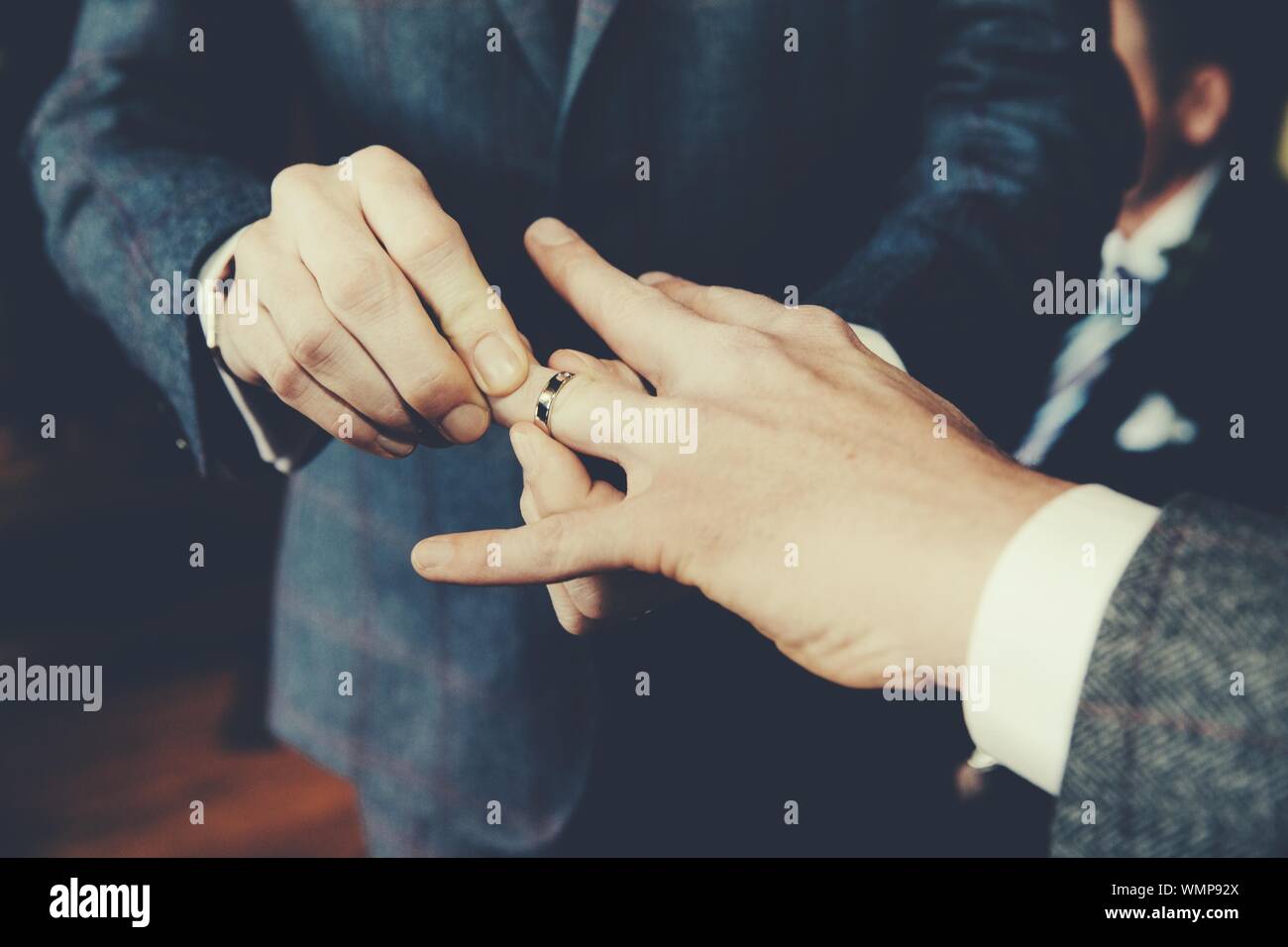 Gay Men Exchanging Rings At Wedding Ceremony Stock Photo