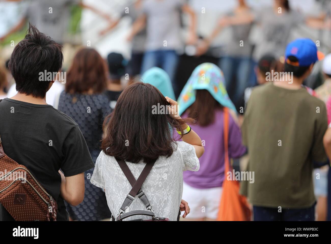 Rear View Of Spectators Enjoying Street Dance During Traditional Festival Stock Photo