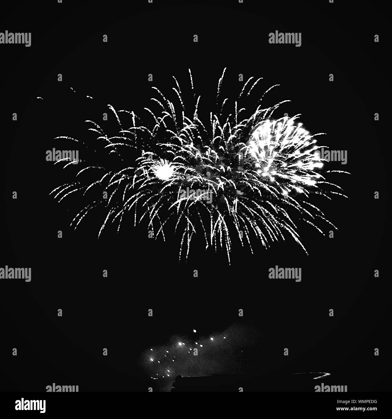 Firework display in sky celebration Black and White Stock Photos
