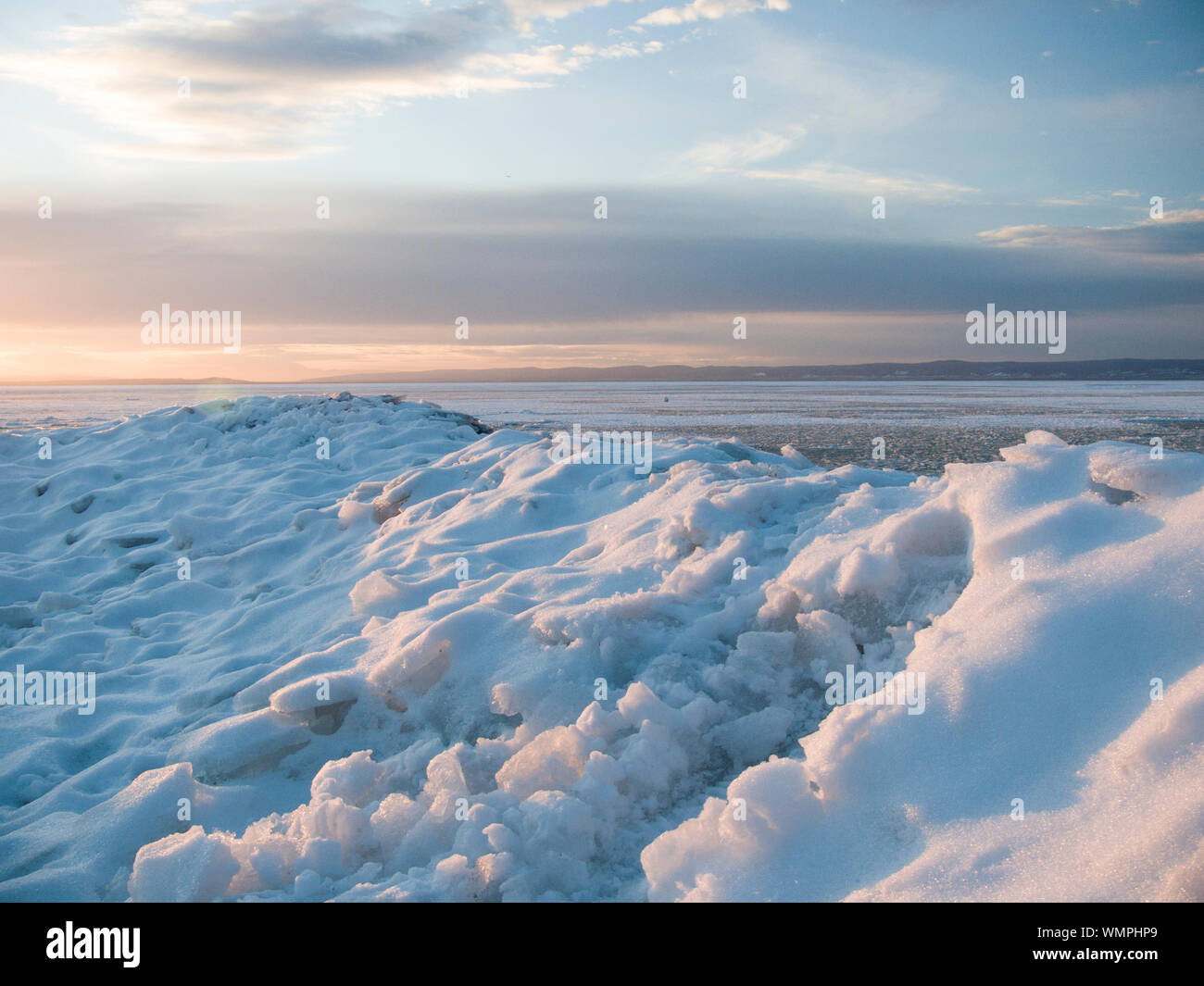 Scenic View Of Frozen Lake Neusiedl Against Sky During Sunset Stock Photo