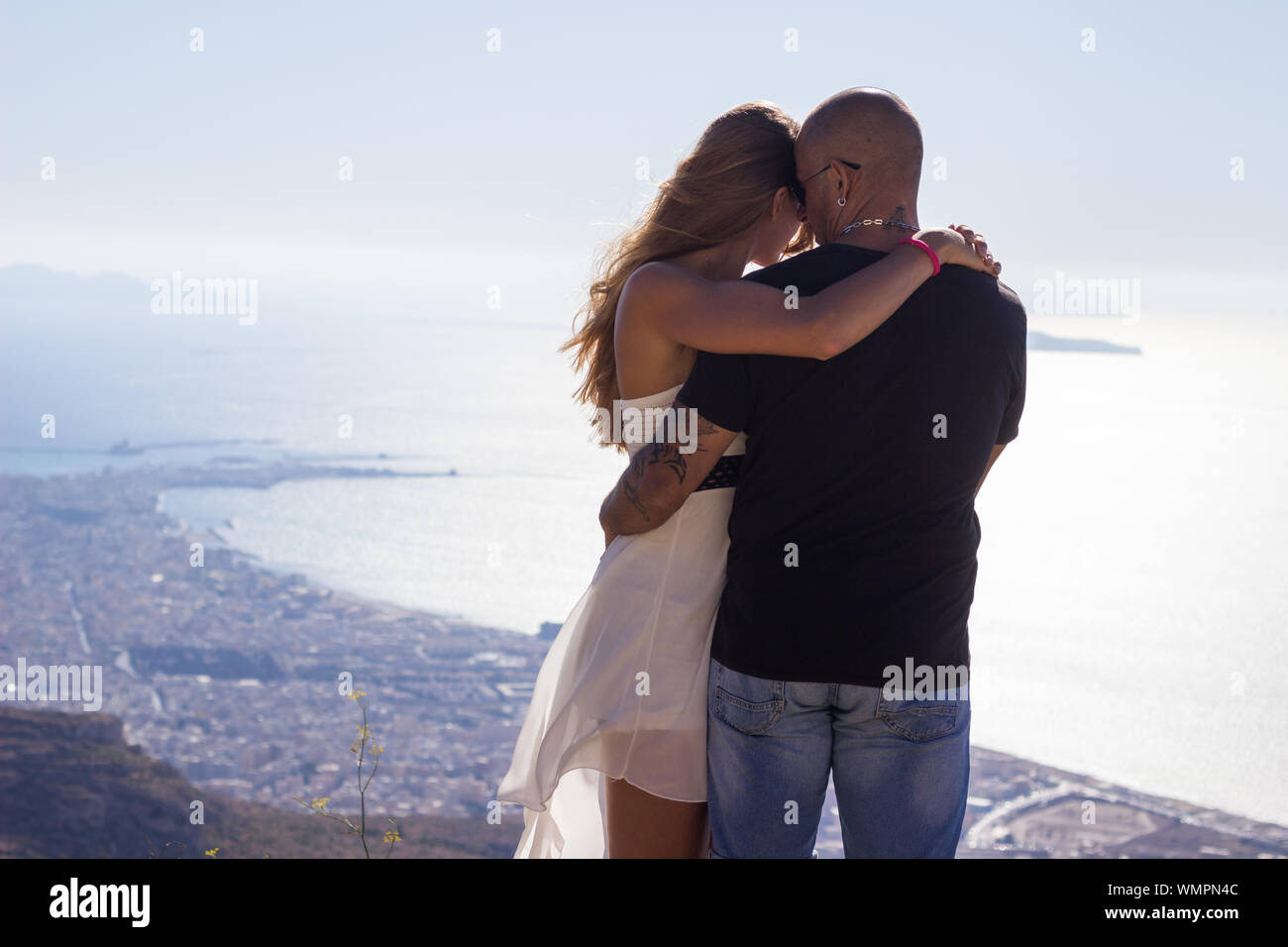 Couple on mountain top enjoying sea and landscape view Stock Photo