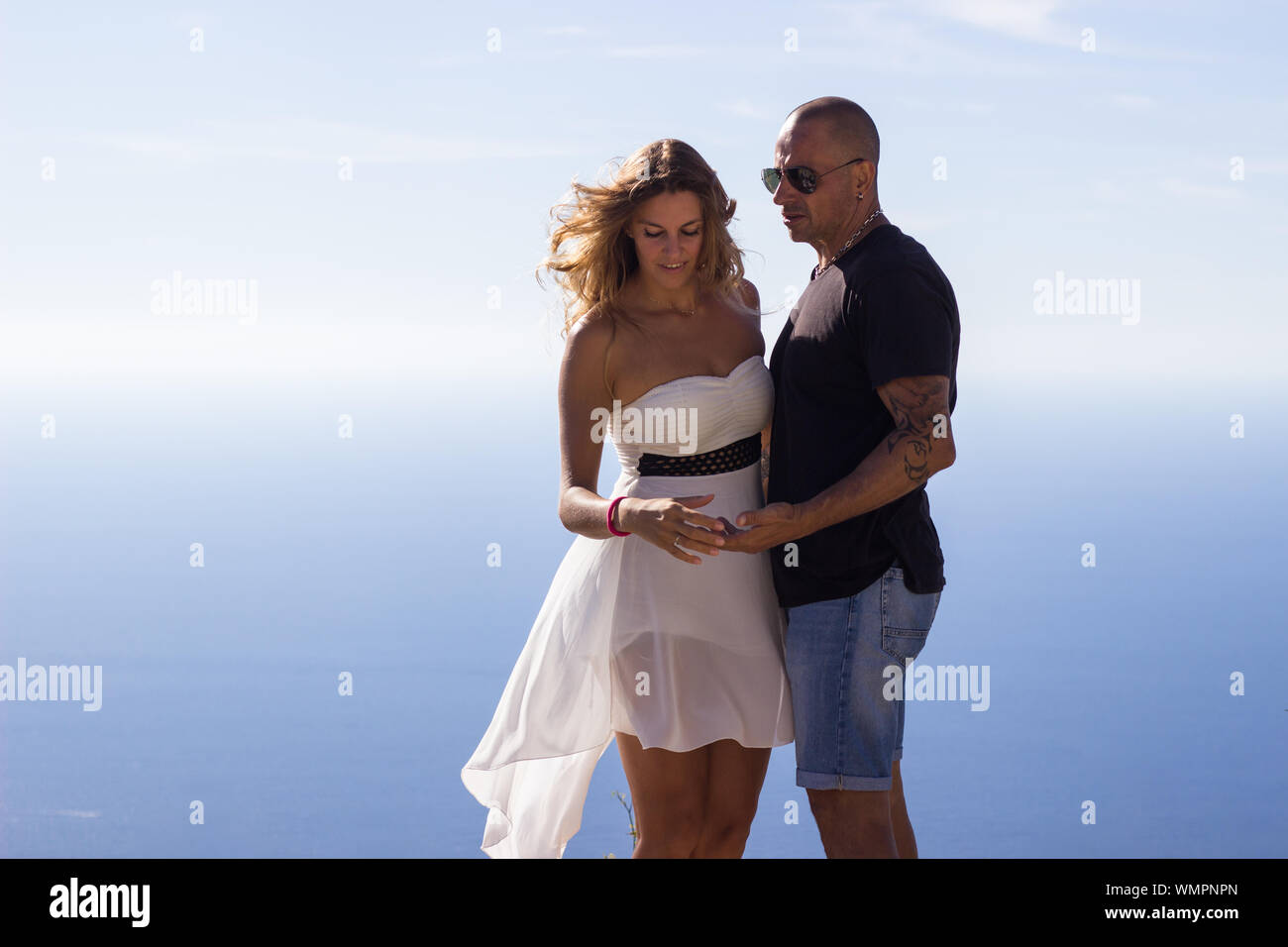 Couple hugging enjoying seascape on summer day Stock Photo