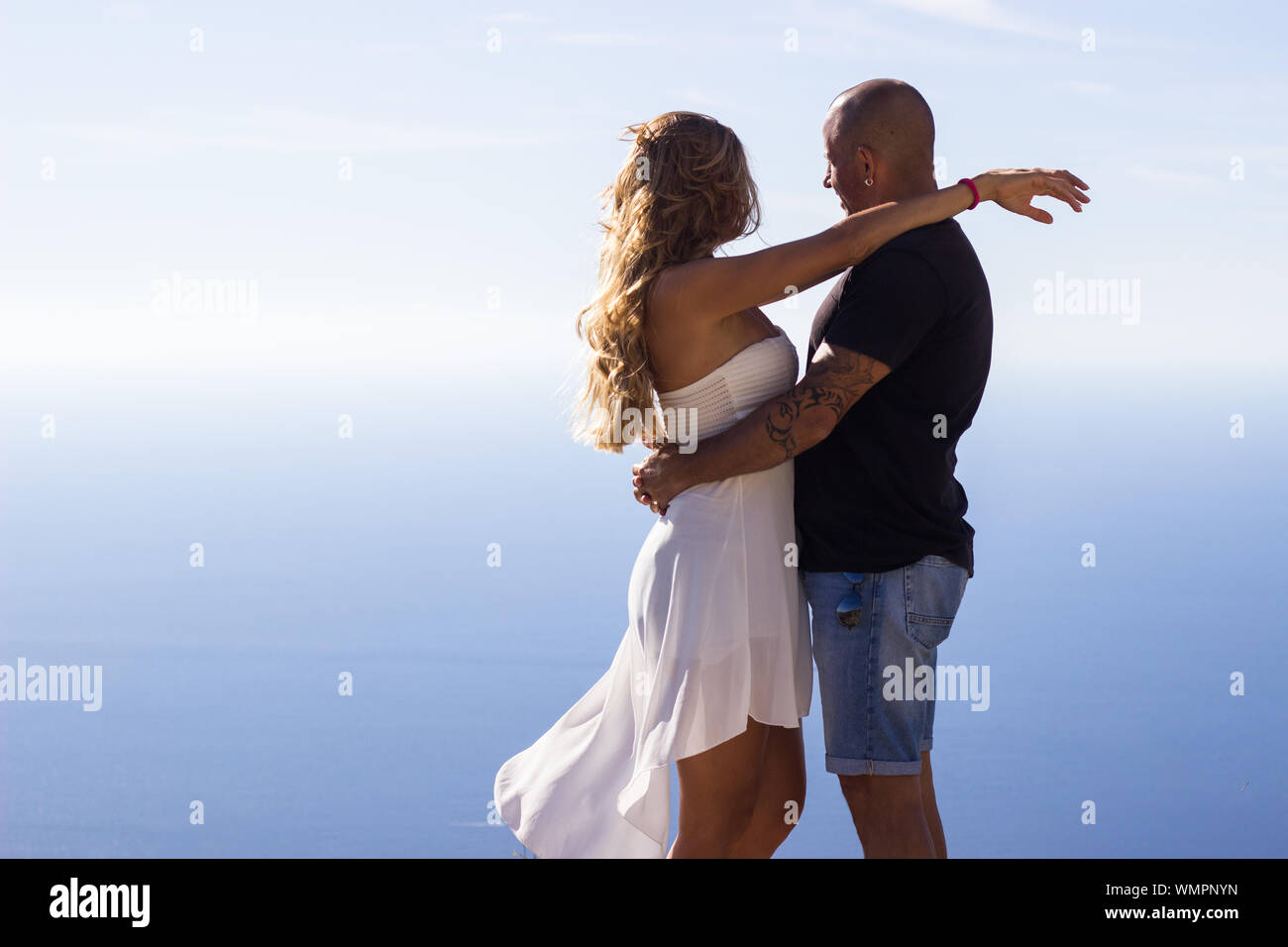 Couple hugging enjoying seascape on summer day Stock Photo