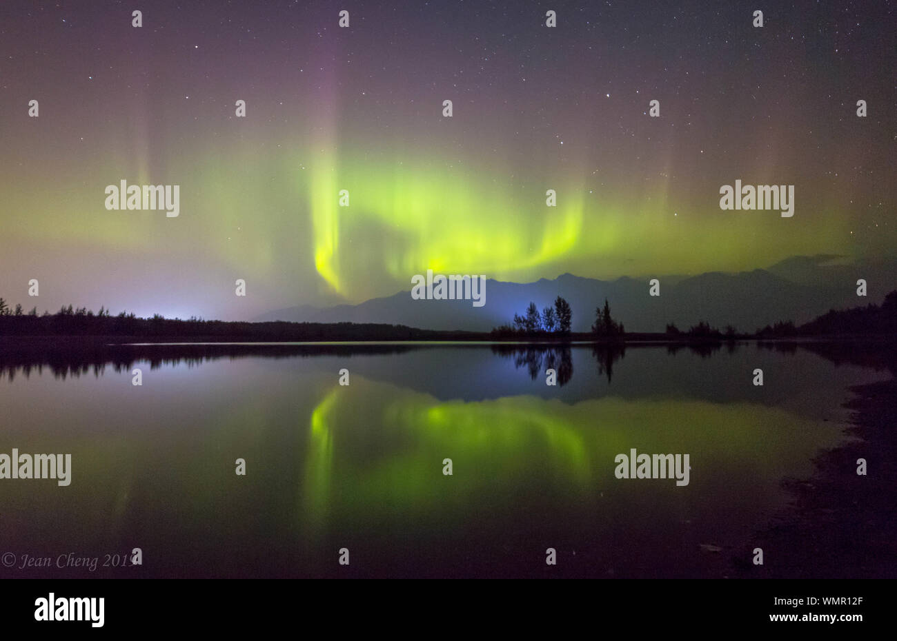 Northern lights dance over reflective water in Alaska 2019 Stock Photo ...