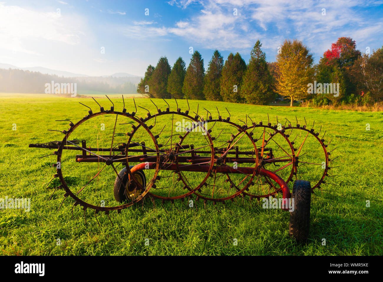 Antique farm implement in a farming landscape, Stowe Vermont, USA Stock
