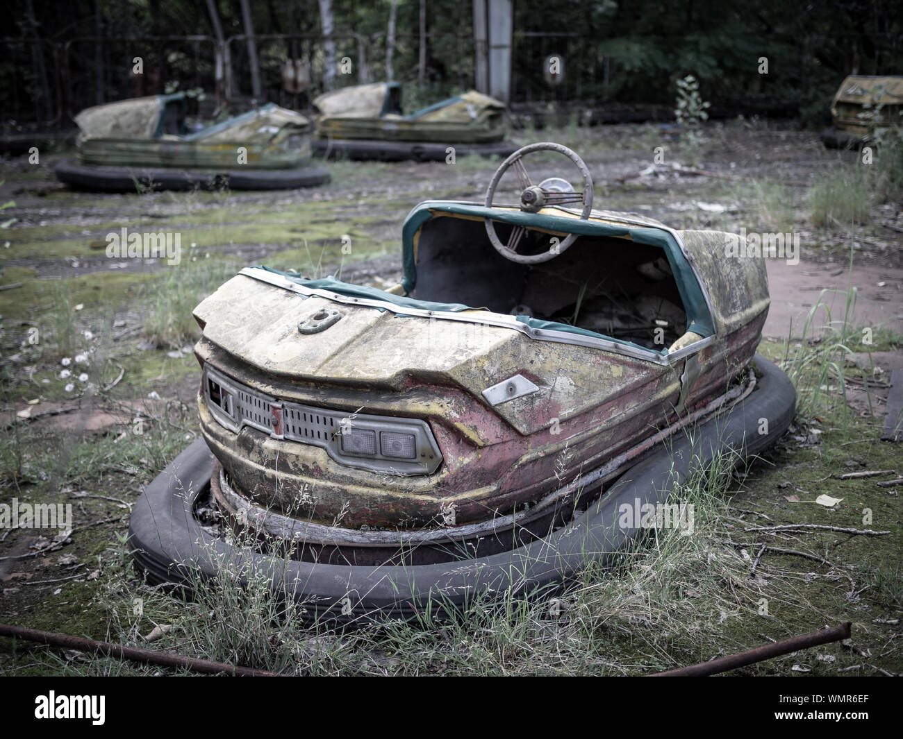 Abandoned rusty bumper cars (aka dodgems, bumping cars, dodging cars, dashing cars) in the Pripyat amusement park, Chernobyl Exclusion Zone, Ukraine Stock Photo