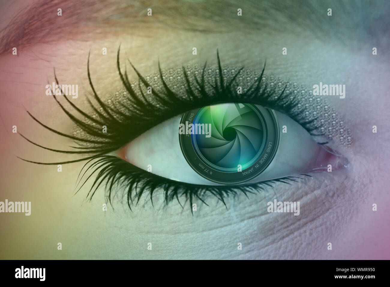 Eye with camera zoom lens as the iris, long eye lashes and a rainbow overlay Stock Photo