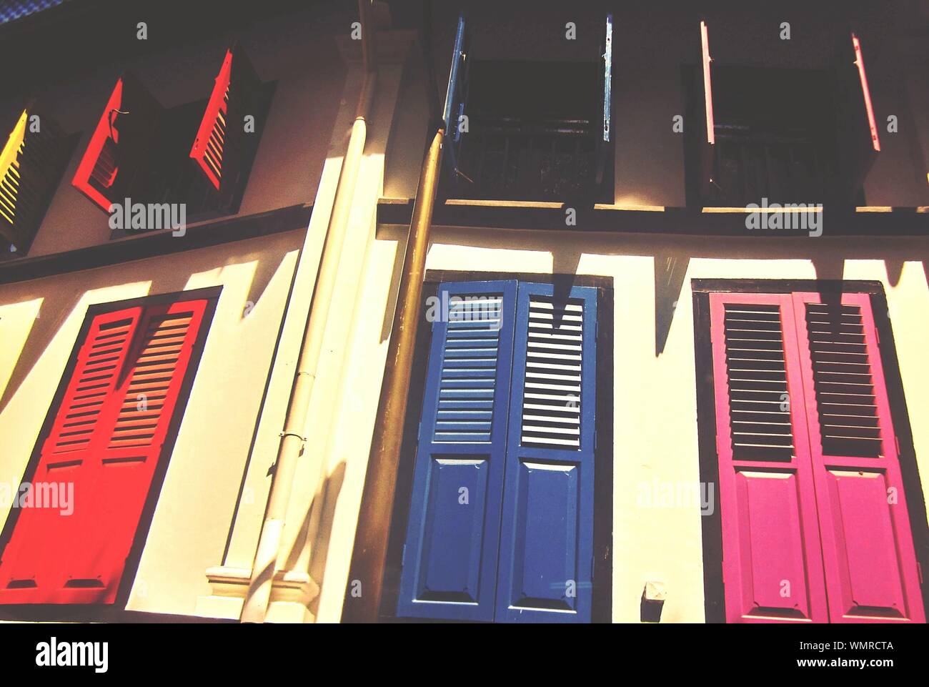 Low Angle View Of House With Closed Doors And Open Windows