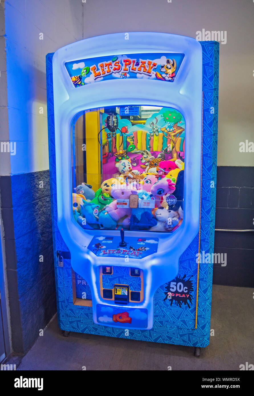 Claw Crane vending machine game featuring plush toy prizes is at the  entrance to a Department Store in Florida Stock Photo - Alamy