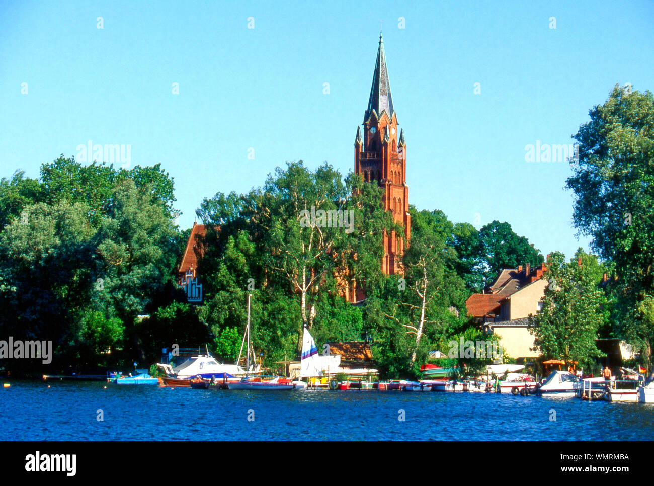 Clock Tower By Muritz Lake Against Sky Stock Photo