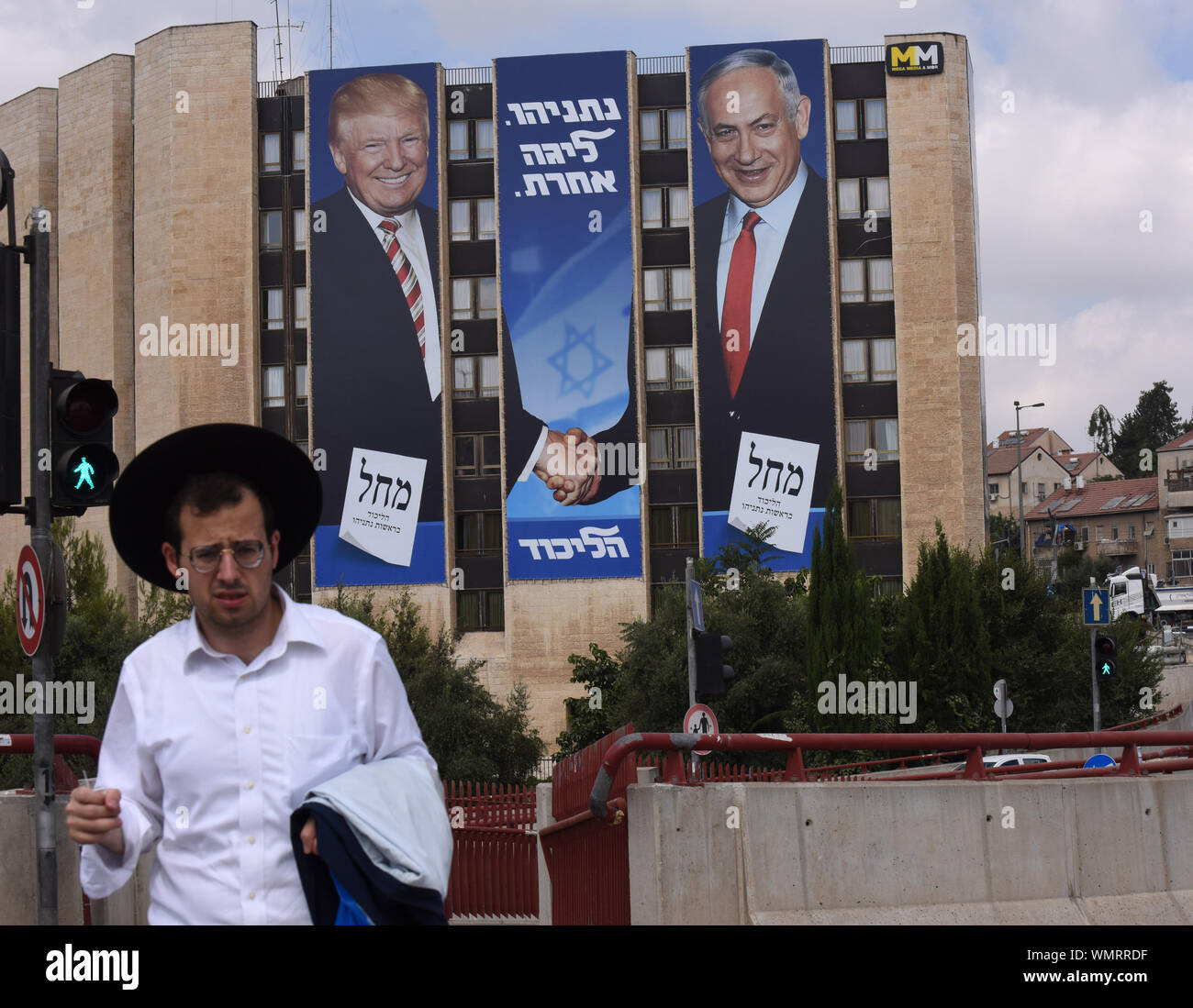 Jerusalem, Israel. 5th Sep 2019. A man walk near a large election campaign poster with a photo of U.S. President Donald Trump shaking hands with Israeli Prime Minister Benjamin Netanyahu in Jerusalem, Thursday, September 5, 2019. The poster reads in Hebrew 'Netanyahu Is In A League Of His Own.' Israelis return to the polls on September 17, for the second national election in 2019.  Photo by Debbie Hill/UPI Credit: UPI/Alamy Live News Stock Photo