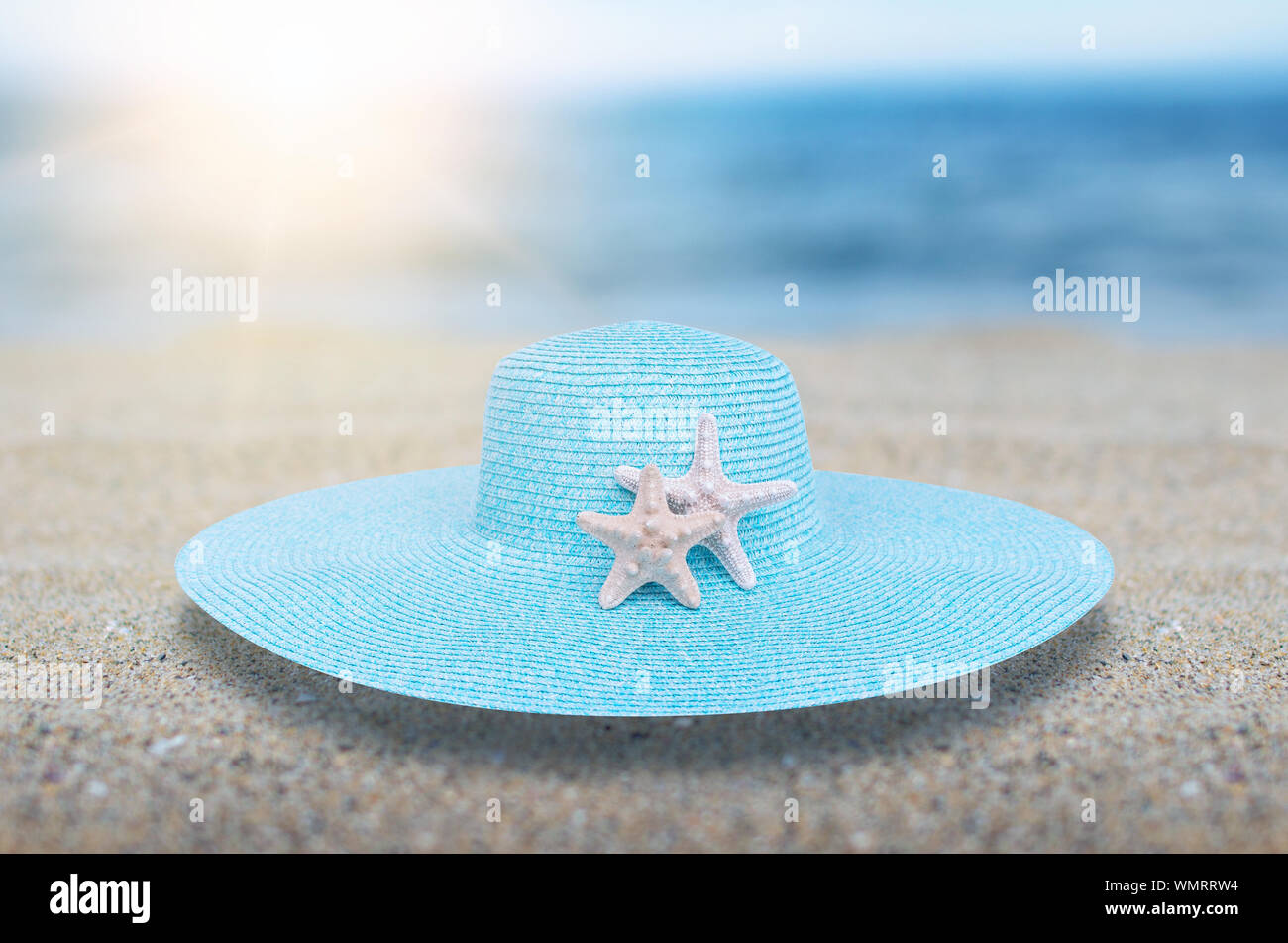 Hat seashell and sea stars on sea sand Stock Photo - Alamy