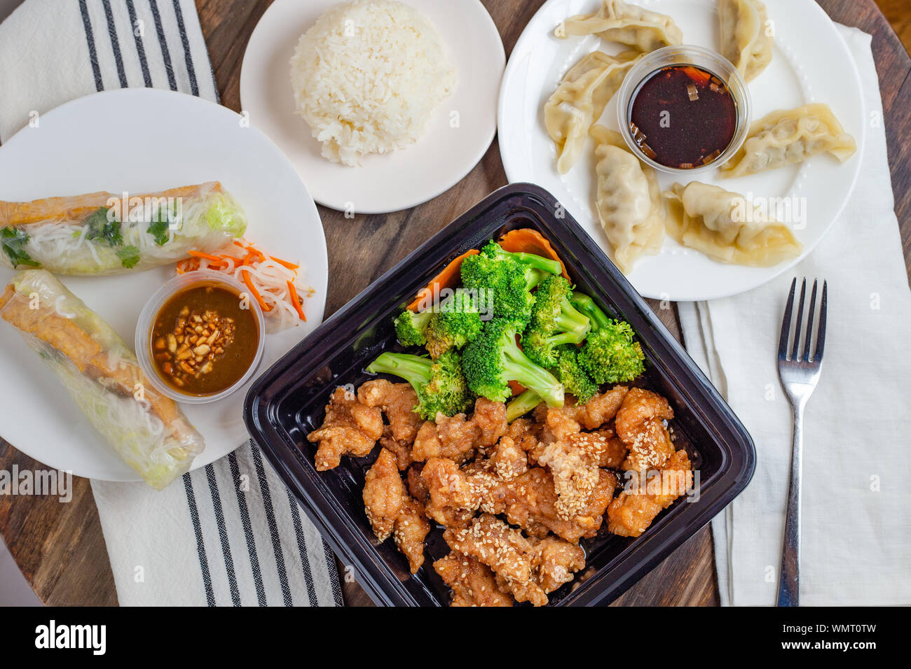 Vietnamese meal of sesame chicken, spring rolls and potstickers shot from above Stock Photo
