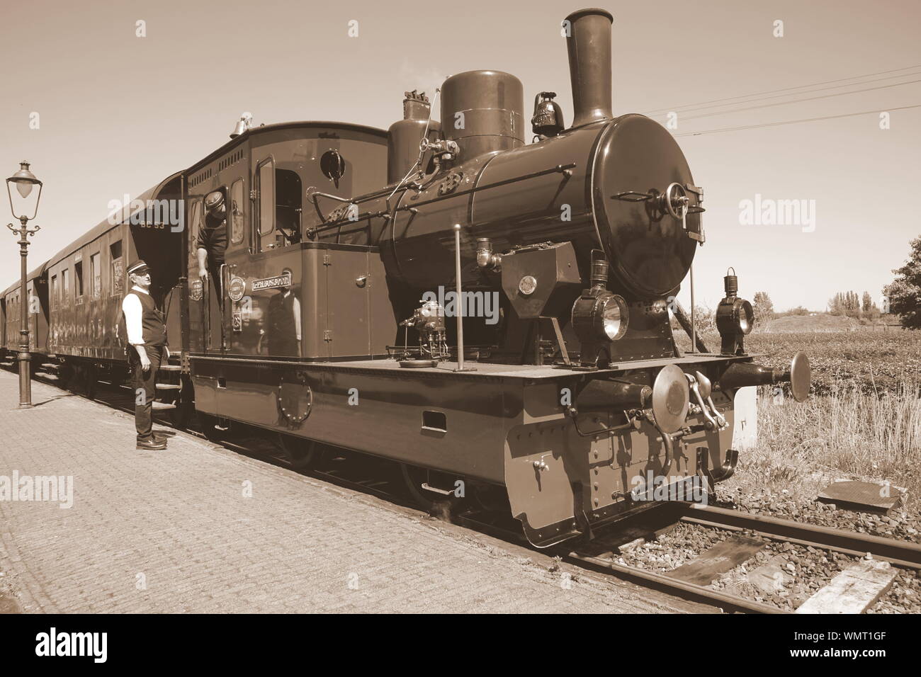 Wognum, the Netherlands - May 6, 2018:  Dutch historical steam tram, conductor and steam engine operator Stock Photo