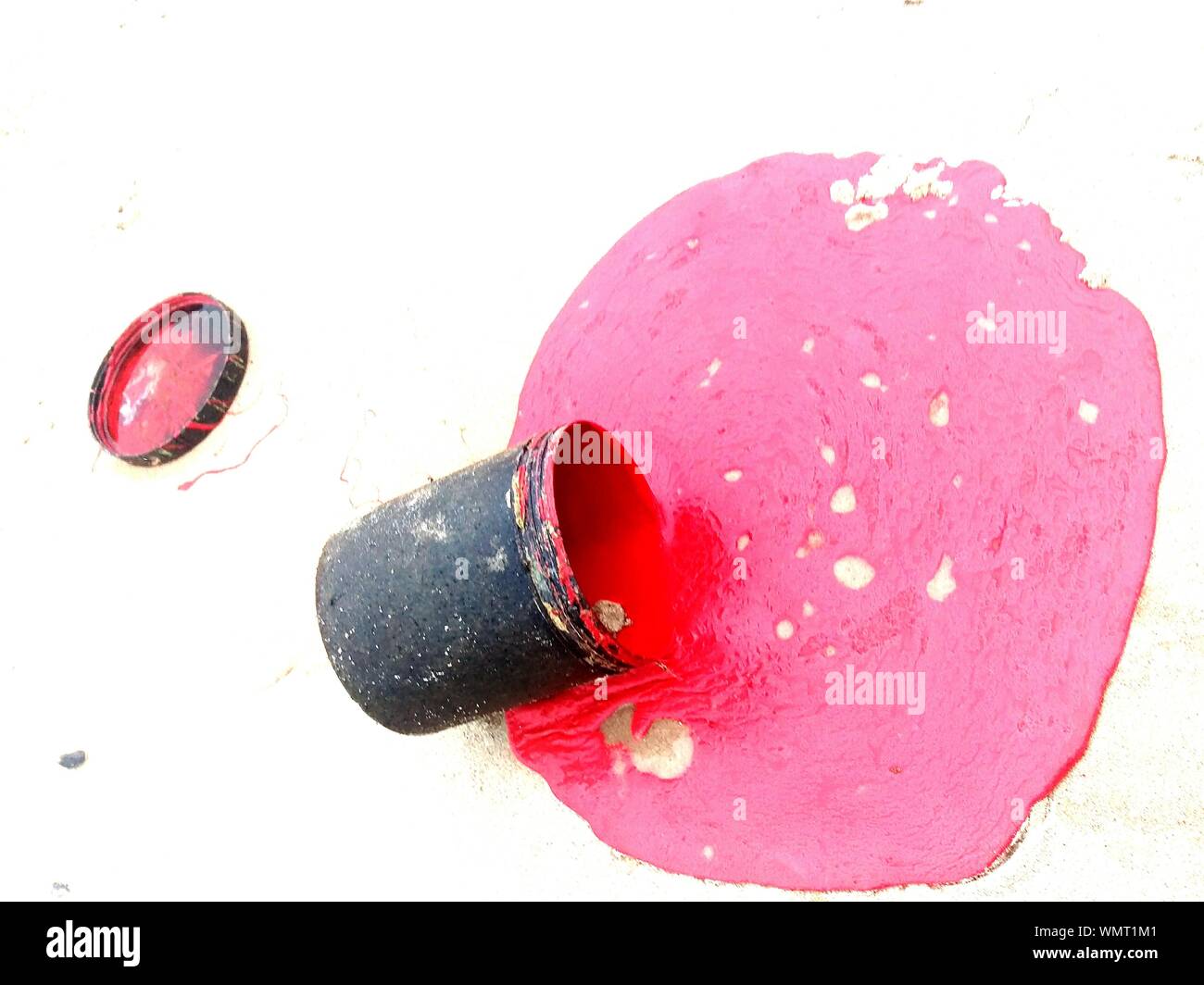 High Angle View Of Red Paint Fallen From Can At Beach Stock Photo