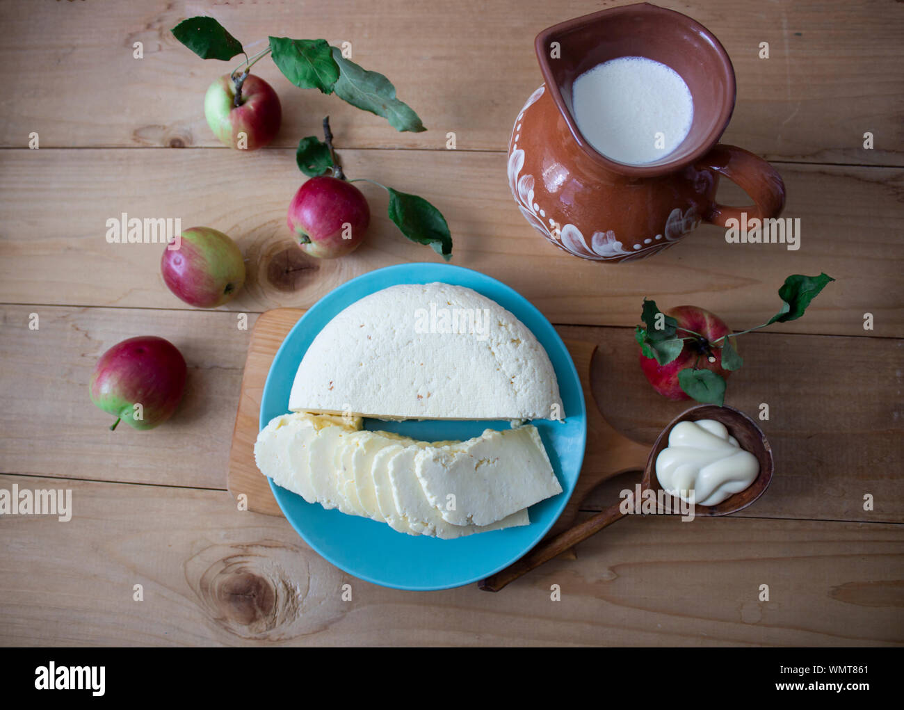 Tasty fresh milk is one of the main sources of nutrition. Mozzarella. Milk, cheese and apples. Rustic food. On a wooden background. View from above. c Stock Photo