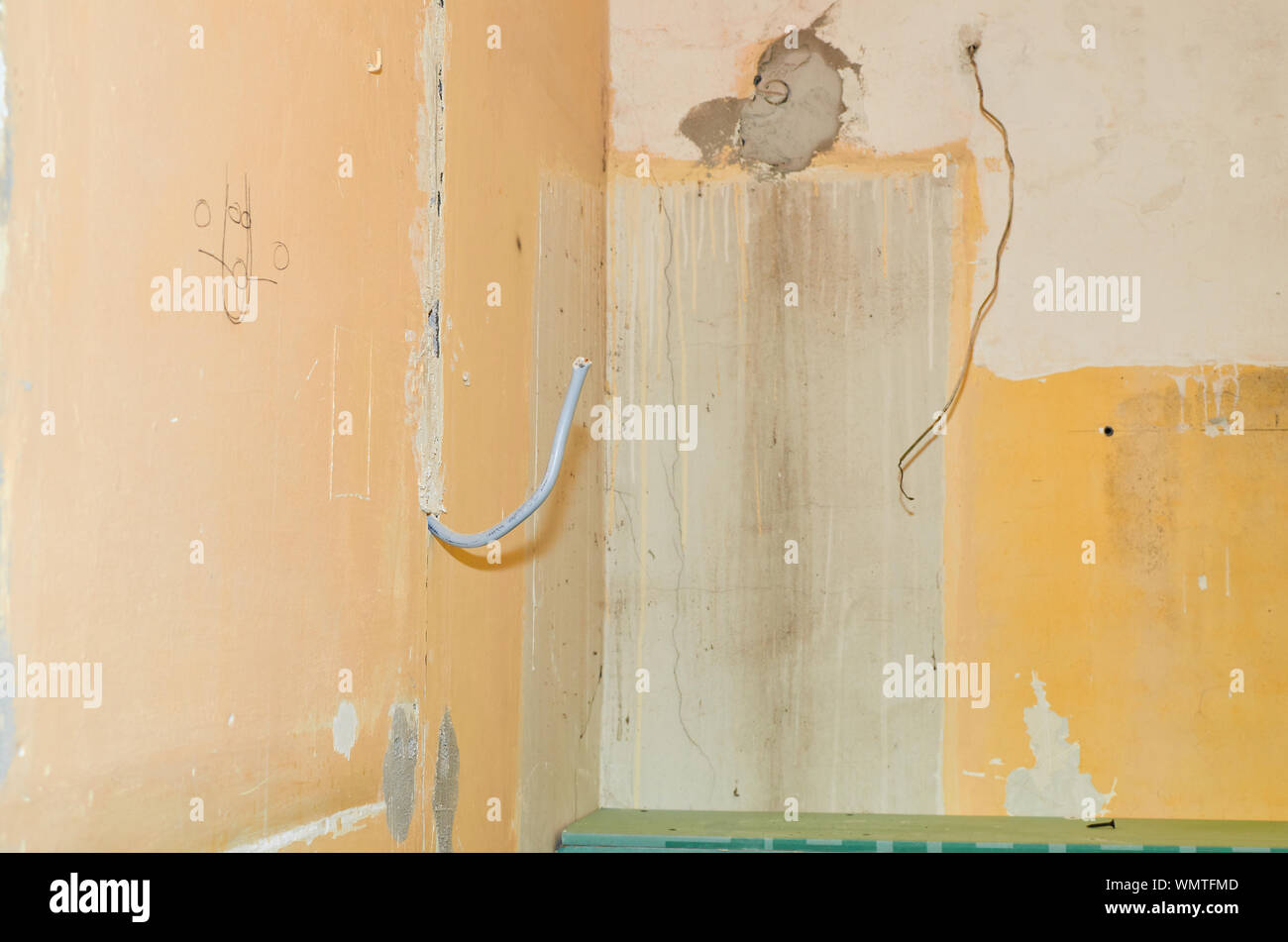 Installation of a new electric cable in a wall during renovation works