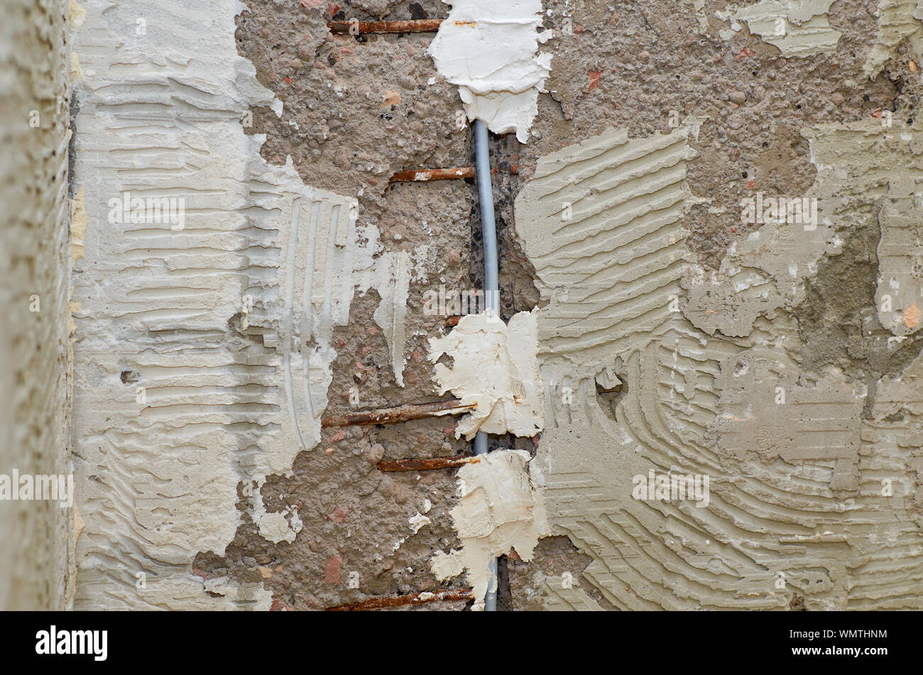 Installation of a new electric cable in a wall during renovation works