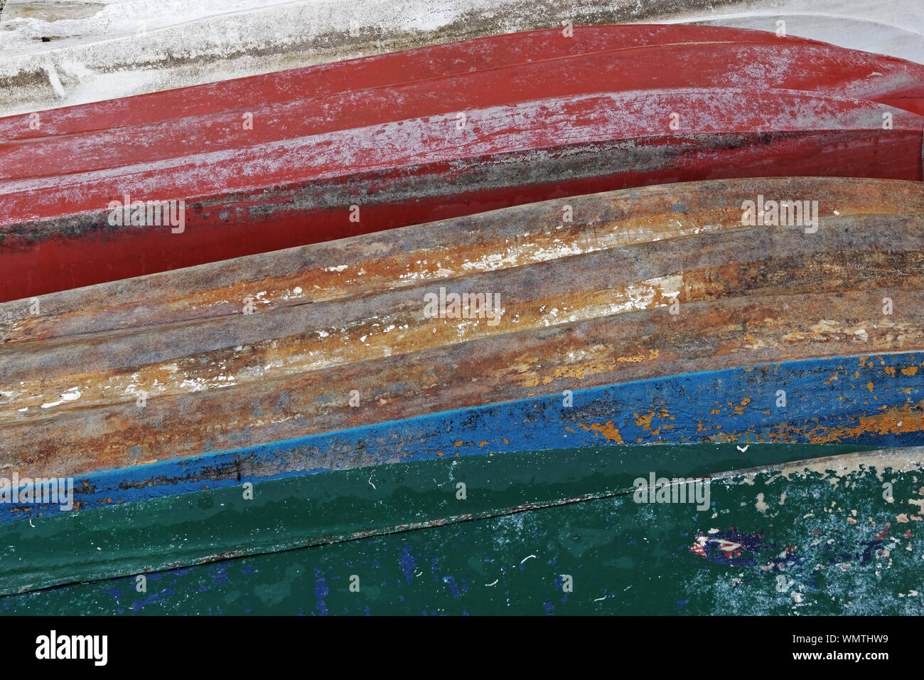 peeling paint of old boats, keels form an abstract pattern Stock Photo