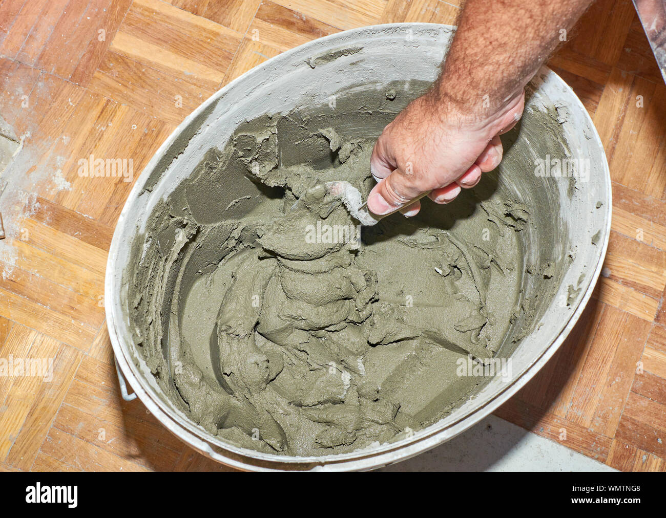 Mixing glue for tiles during renovation works in an apartment Stock Photo Alamy