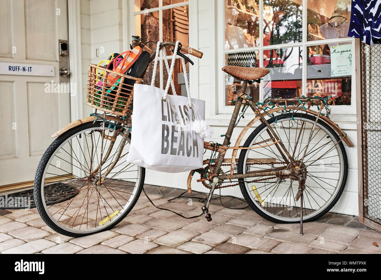 Bicycle decorated and used for advertising in front of a small store front in Seaside Florida, USA. Stock Photo