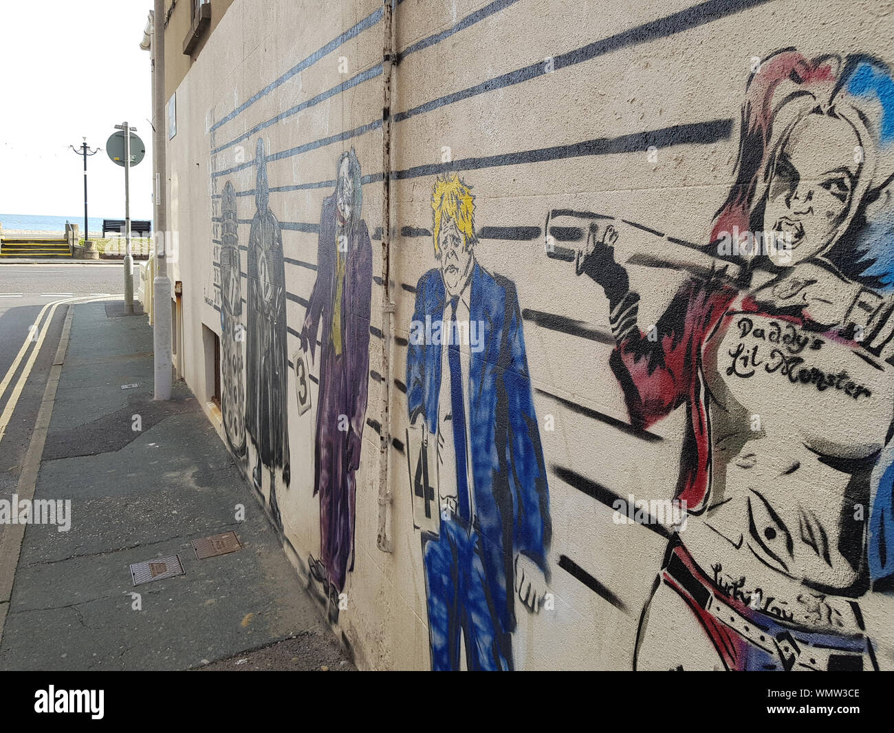 A painted Boris Johnson features in a quirky new mural, accompanied by well-known supervillains Darth Vader and The Joker in a police-style line up. Stock Photo