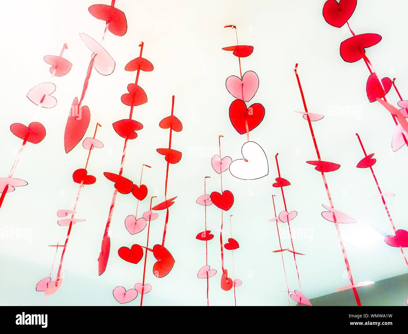 Low Angle View Of Paper Hearts Hanging From Ceiling Stock Photo