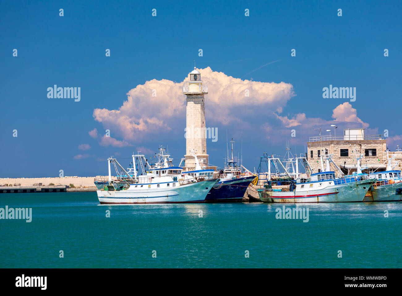 Italy, Apulia, Metropolitan City of Bari, Molfetta. Fishing boats and lighthouse. Stock Photo