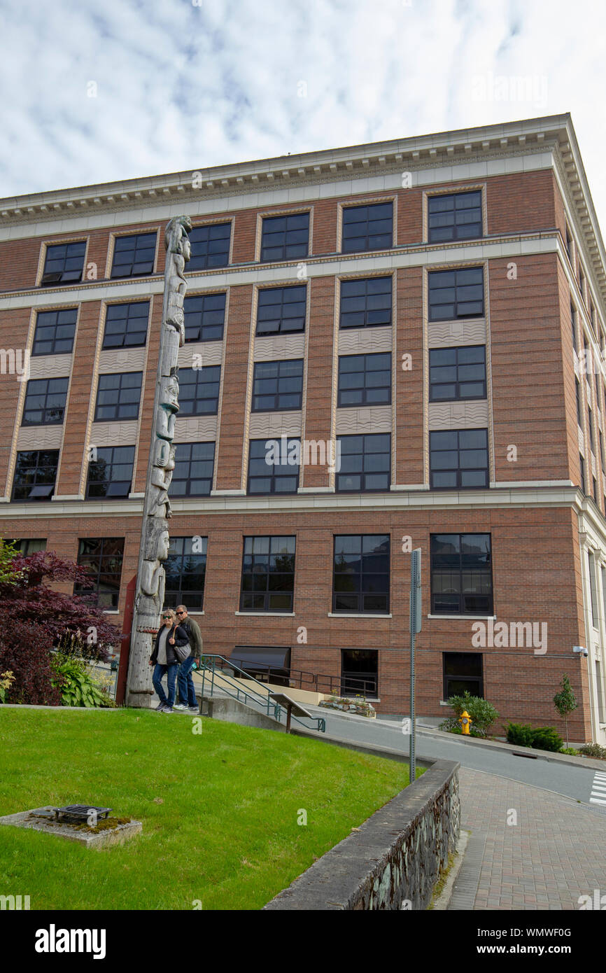 Alaska State Capital building in Juneau Alaska with a totem pole of the