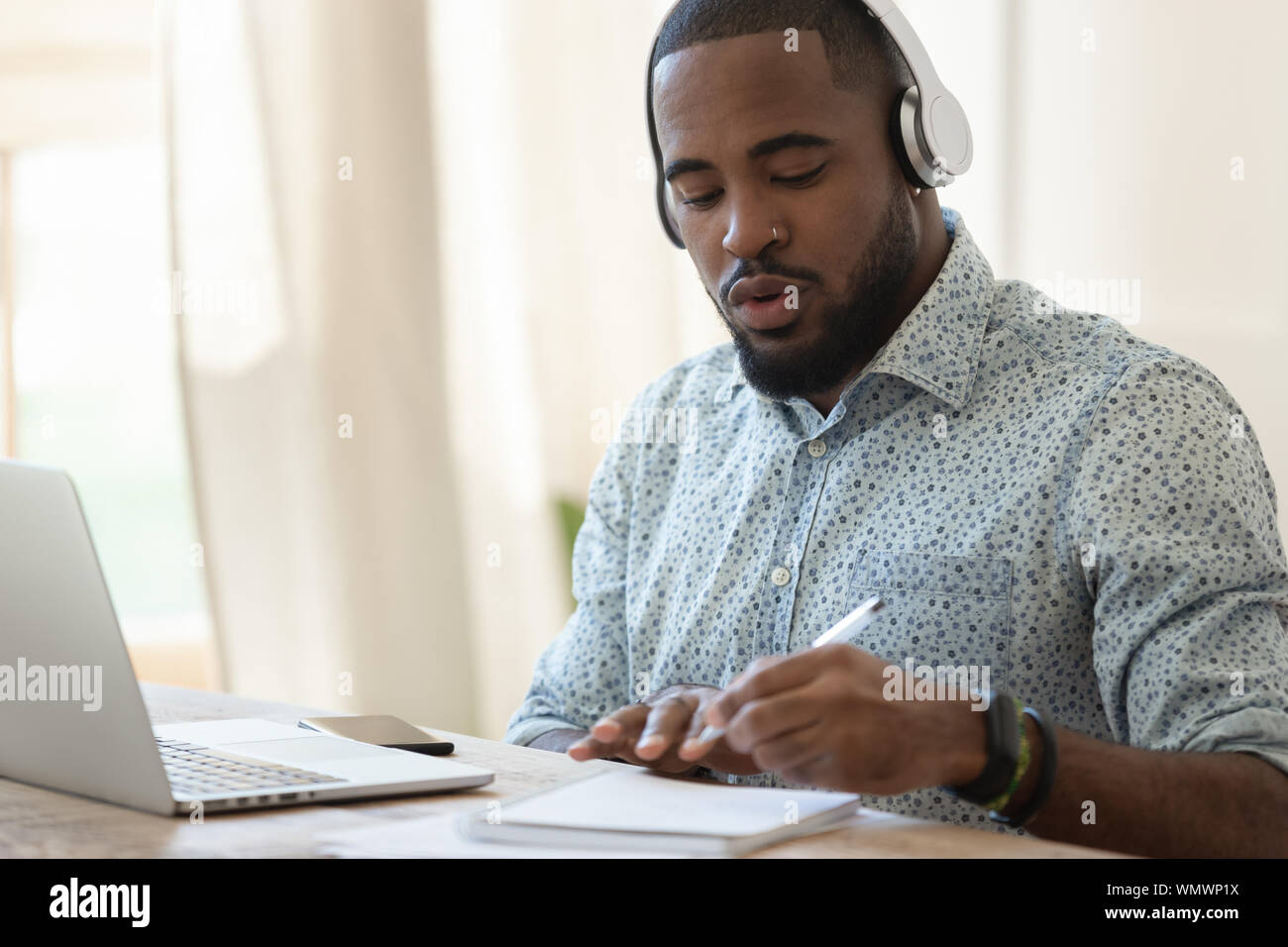 Focused black guy busy with certification training. Stock Photo