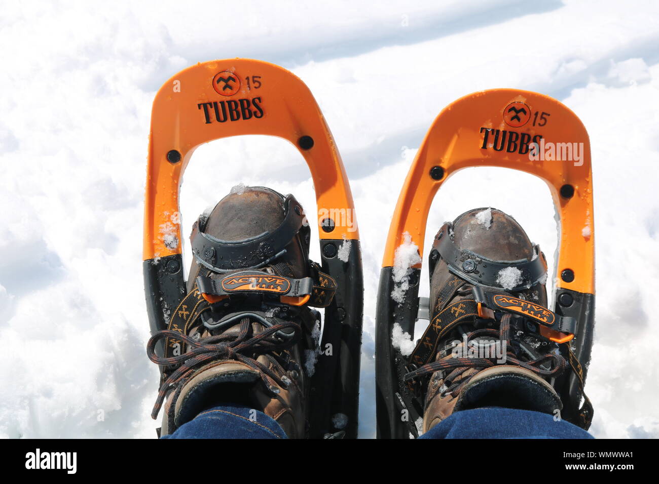 Worn brown hiking boots in Tubbs snowshoes with snow in background Stock  Photo - Alamy