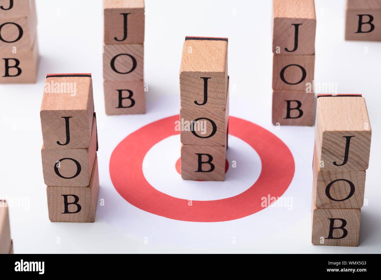 Job Wooden Blocks And Red Darts Target On Desk Stock Photo