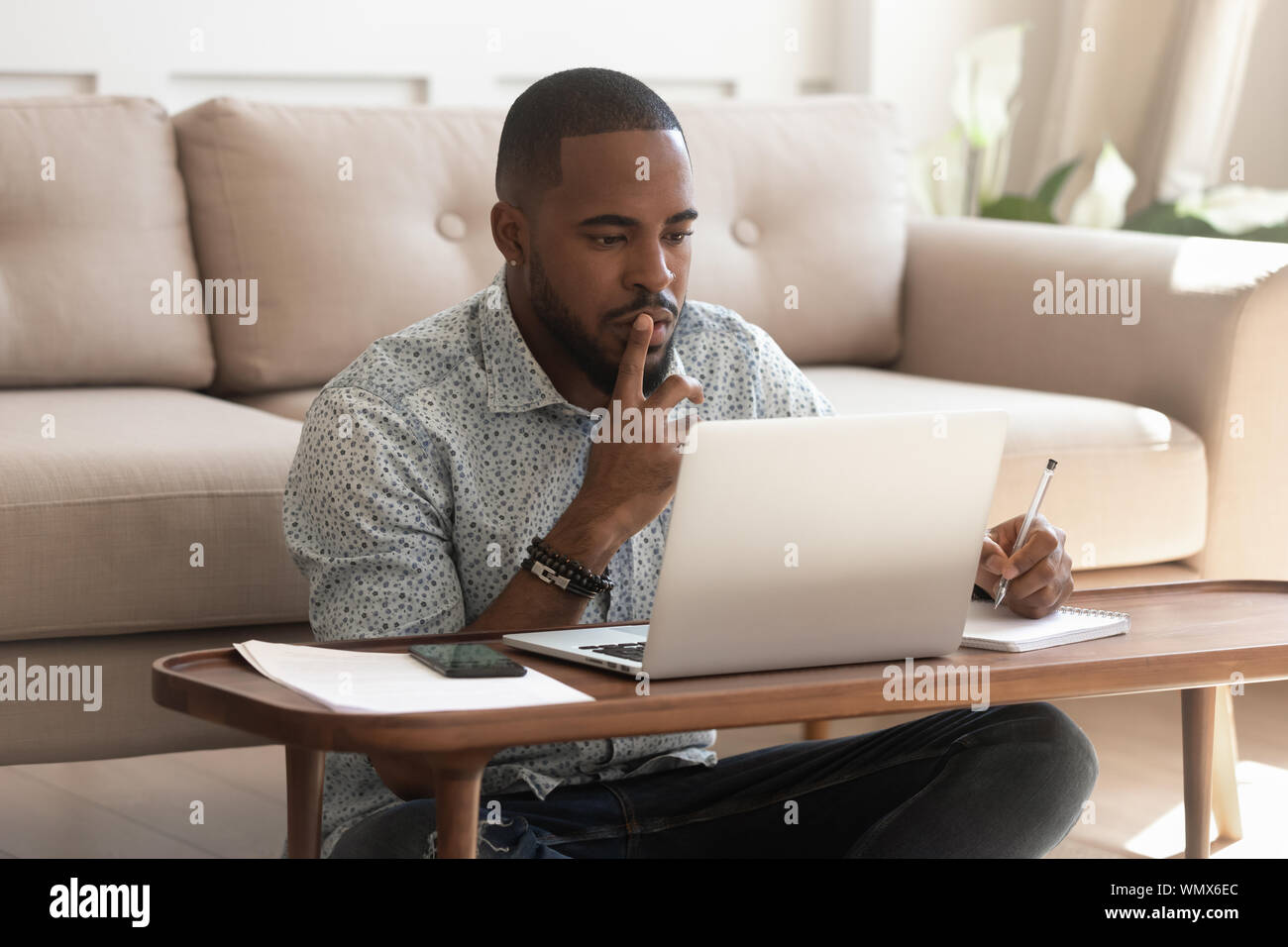 Young african american guy studying on online courses. Stock Photo