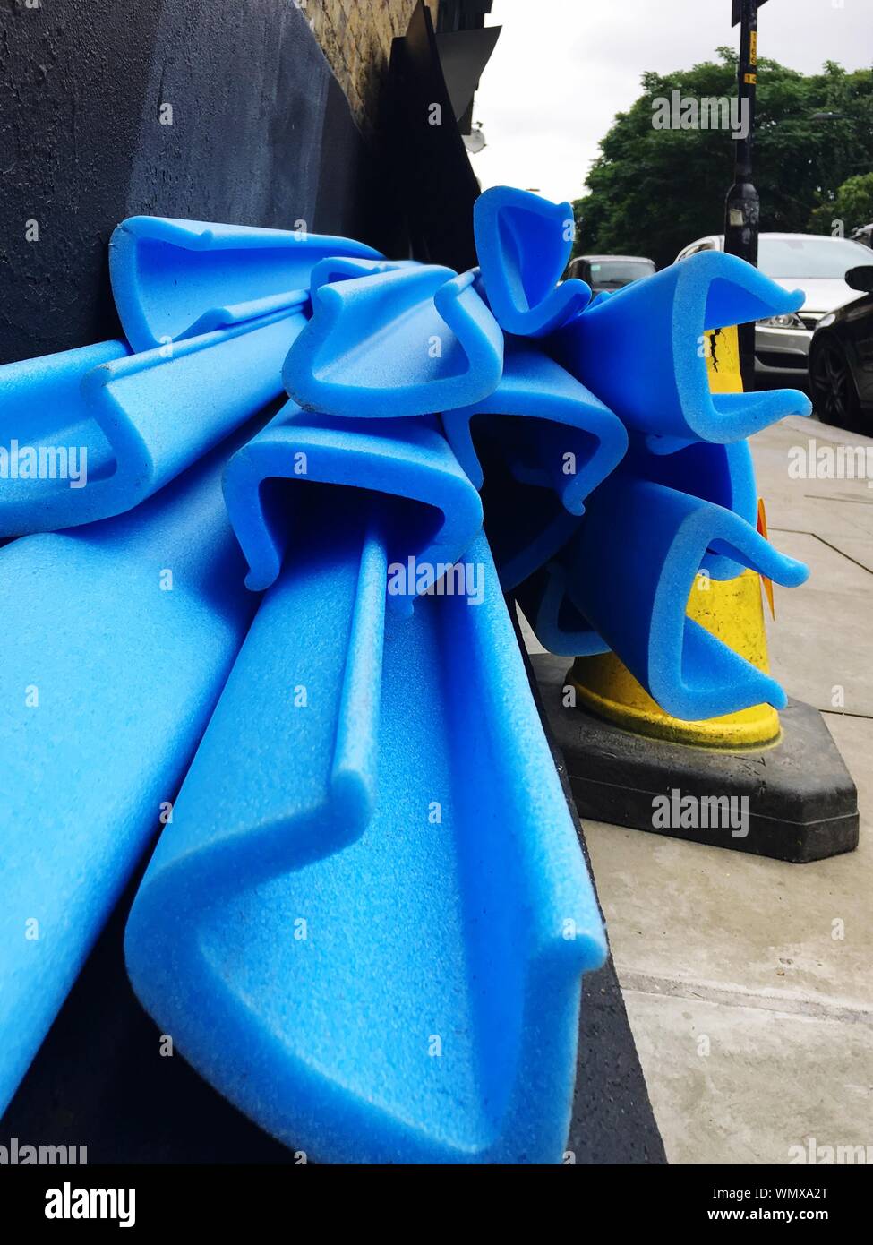 Close-up Of Blue Construction Material And Traffic Cone On Footpath Stock Photo