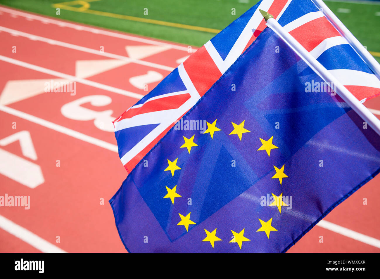 Union Jack and European Union flags flying together at a running track in the Brexit race for the UK to leave the EU Stock Photo