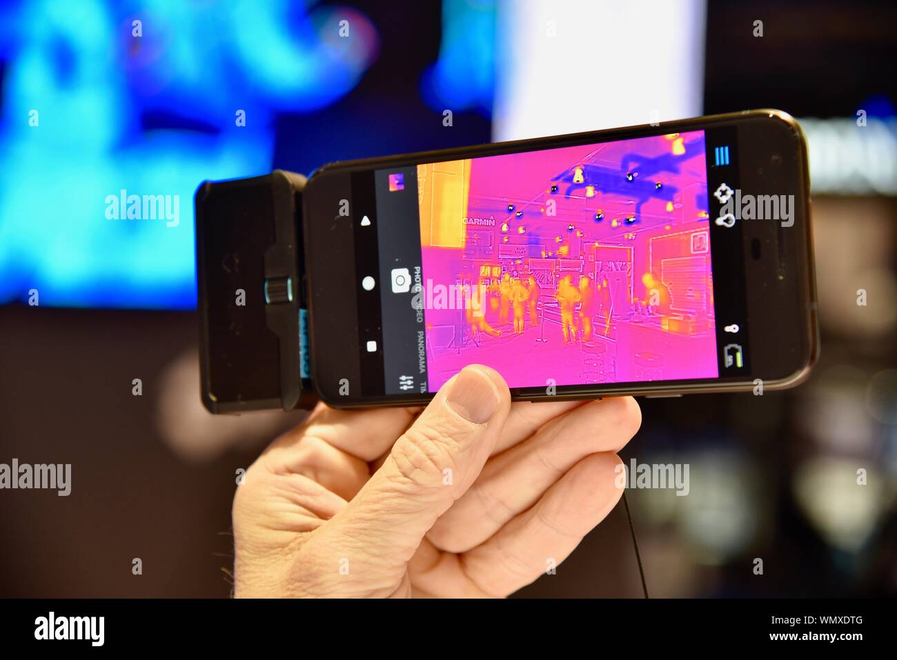 Taking photographs with a FLIR thermal infrared camera on display, with show attendees, at CES (Consumer Electronics Show), Las Vegas, NV, USA Stock Photo