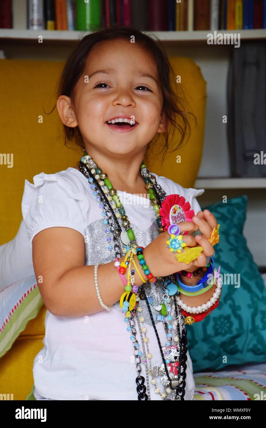 Smiling girl wearing jewelry hi-res stock photography and images - Alamy