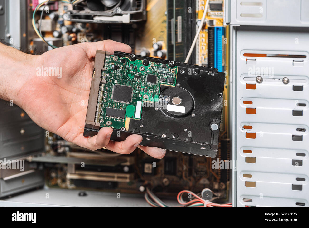 Closeup image of technician man hand changing the hard drive of pc