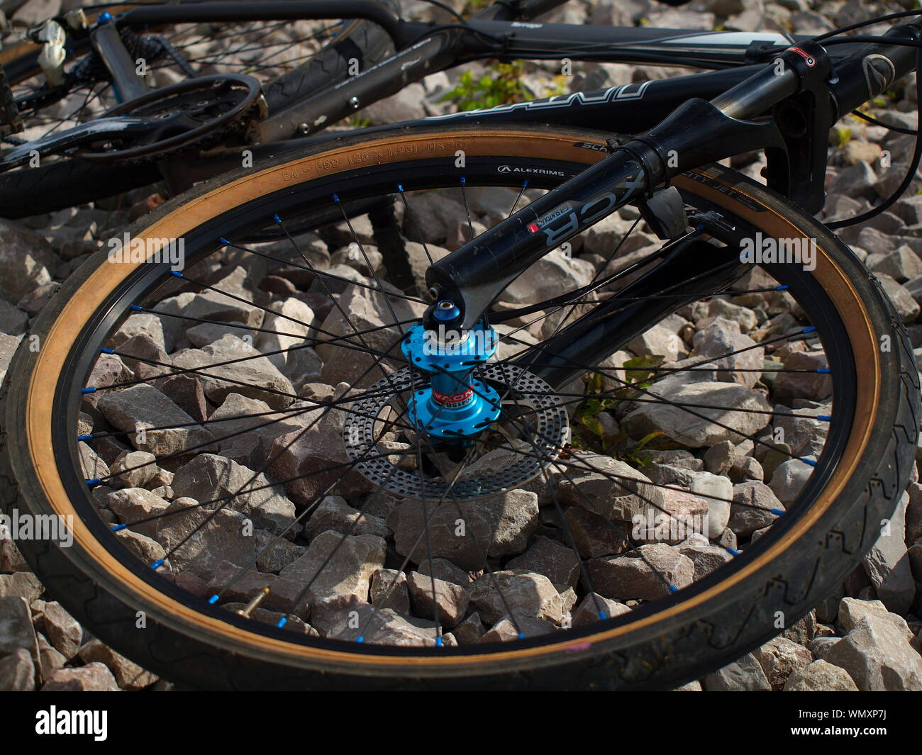 Giant terrago mountain bike with blue anodised hubs and schwalbe city jet  tyres on a gravel beach in north wales england Stock Photo - Alamy