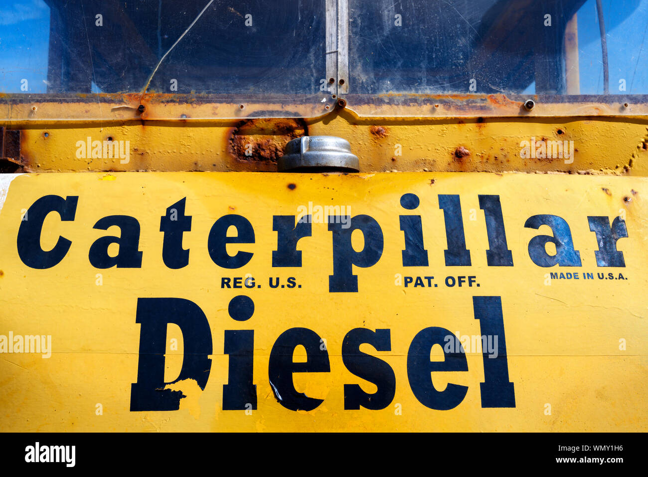 Caterpillar bulldozer used by fishermen to pull boats out of the North sea, Aldeburgh, Suffolk, UK, Stock Photo
