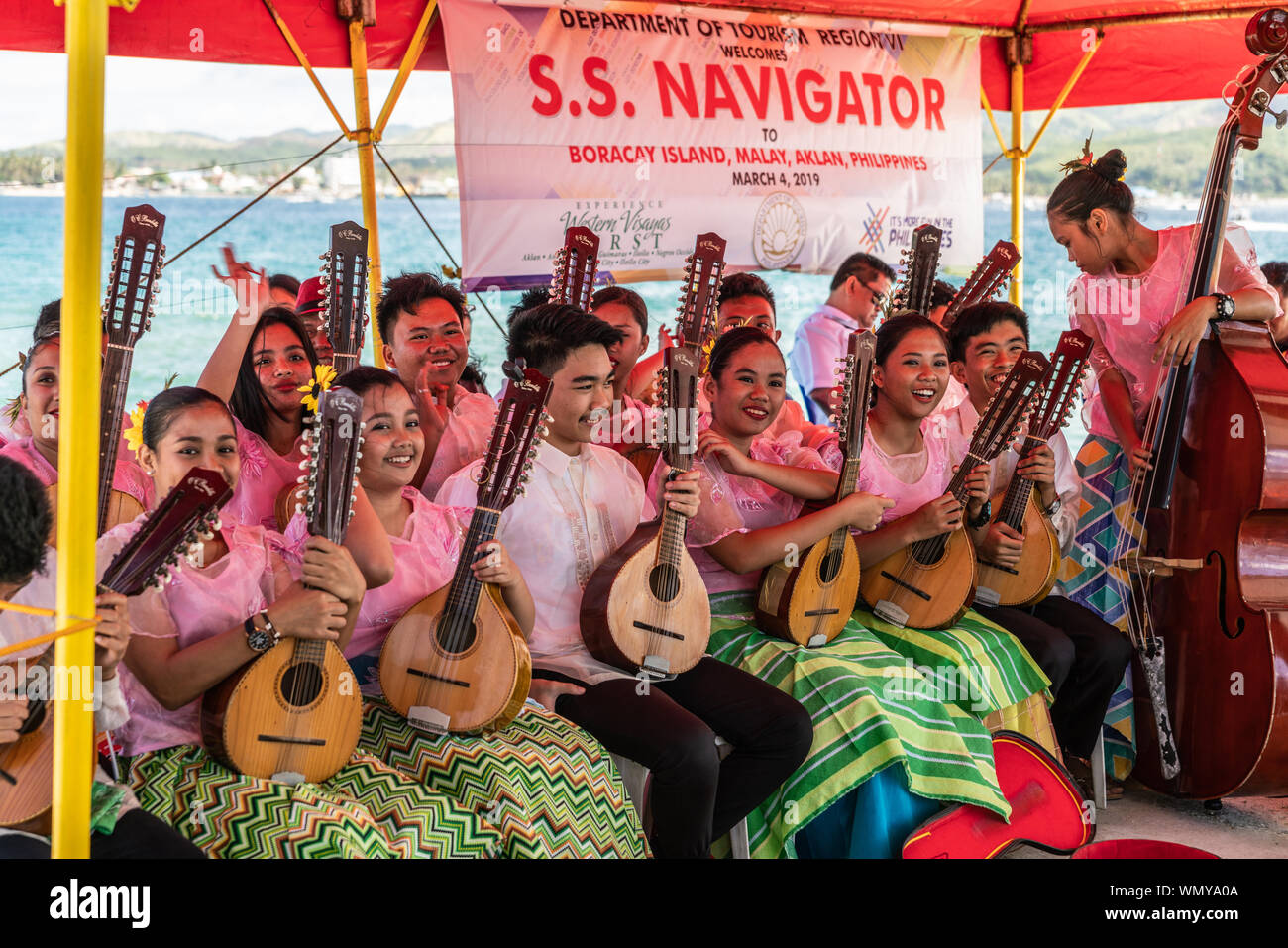 Manoc-Manoc, Boracay, Philippines - March 4, 2019: On Cagban Jetty Port group of traditional folk musicians in folklore dress wellcome tourists of S.S Stock Photo